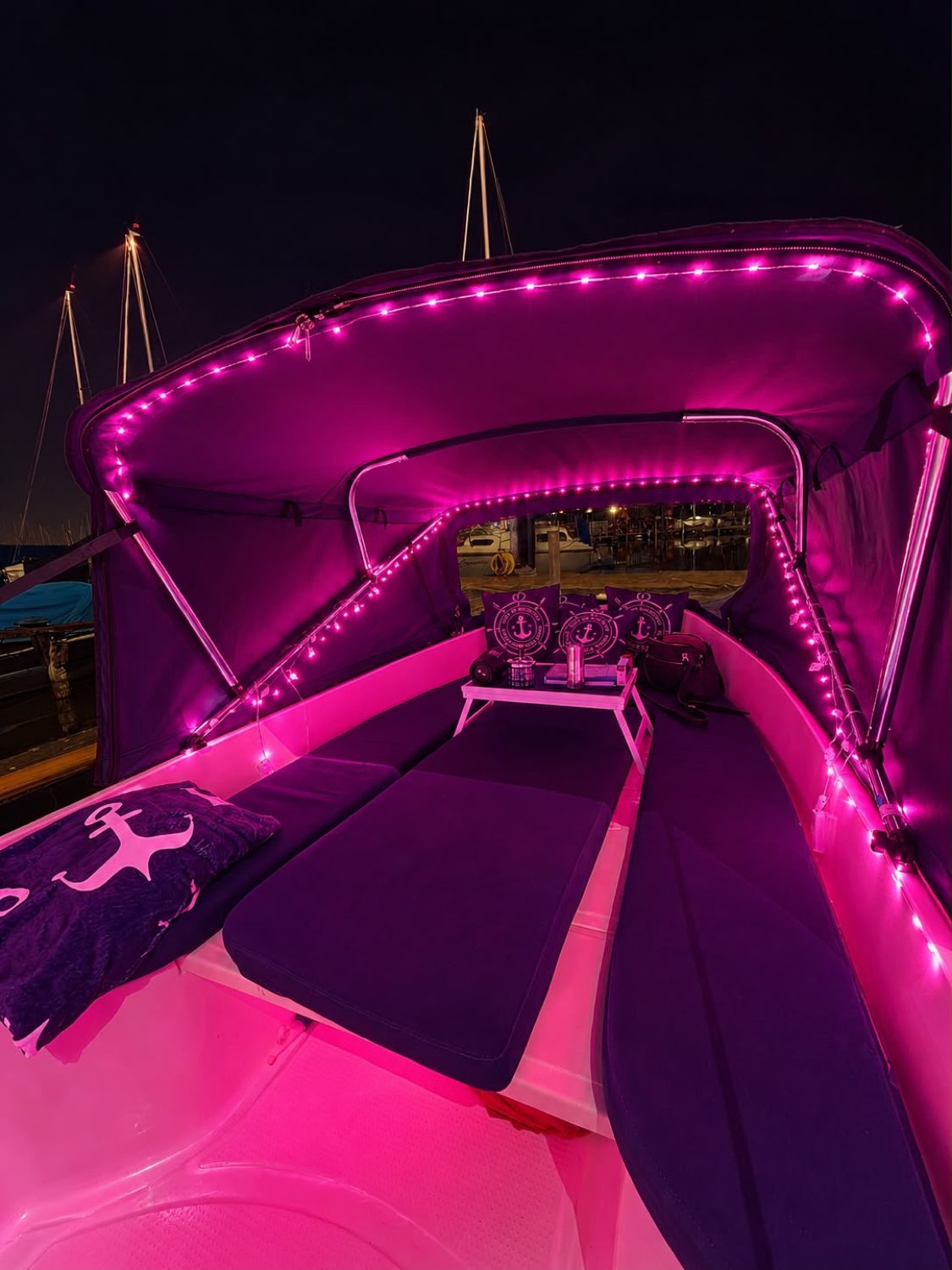 Kuchenbude bei Nacht mit Magenta-LED-Ambiente – Interieur & Meer